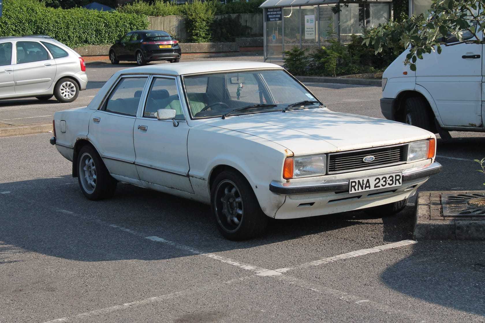 A white Ford Cortina Mk4 1.6 GL four-door saloon, front three-quarter view