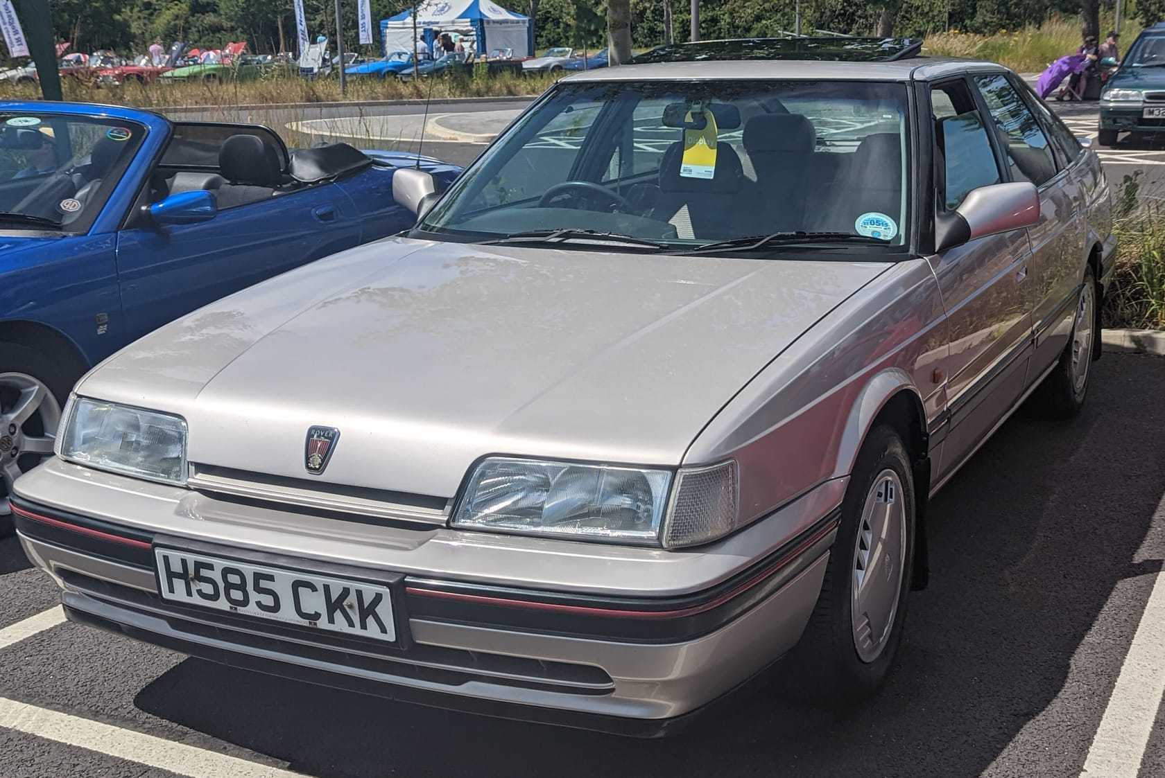 A champagne 1990 Rover 827 Si automatic saloon with a UK registration parked at a classic car show