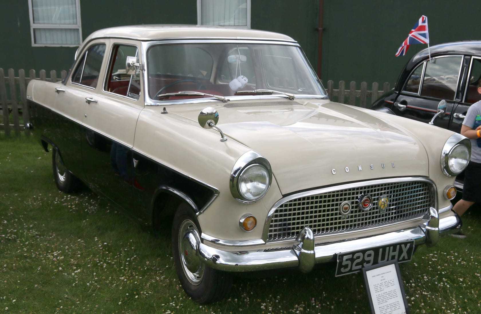 A two-tone cream-and-black Ford Consul Mk2 saloon, front three-quarter view at a show