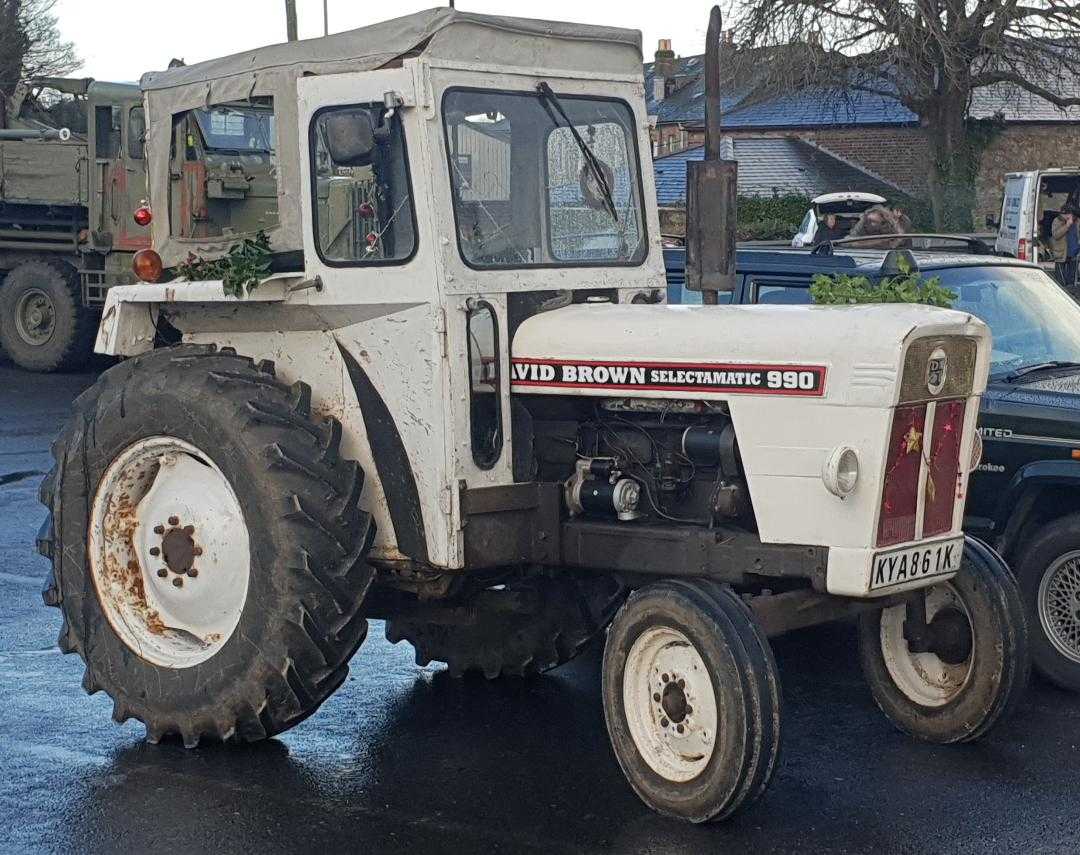 A David Brown Selectamatic 990 tractor in white with a cab, side view, the David Brown Selectamatic 990 name visible on the bonnet