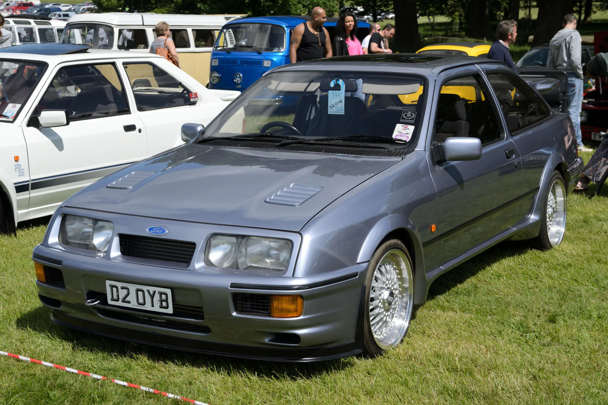 A grey three-door Ford Sierra RS Cosworth, front three-quarter view at a show