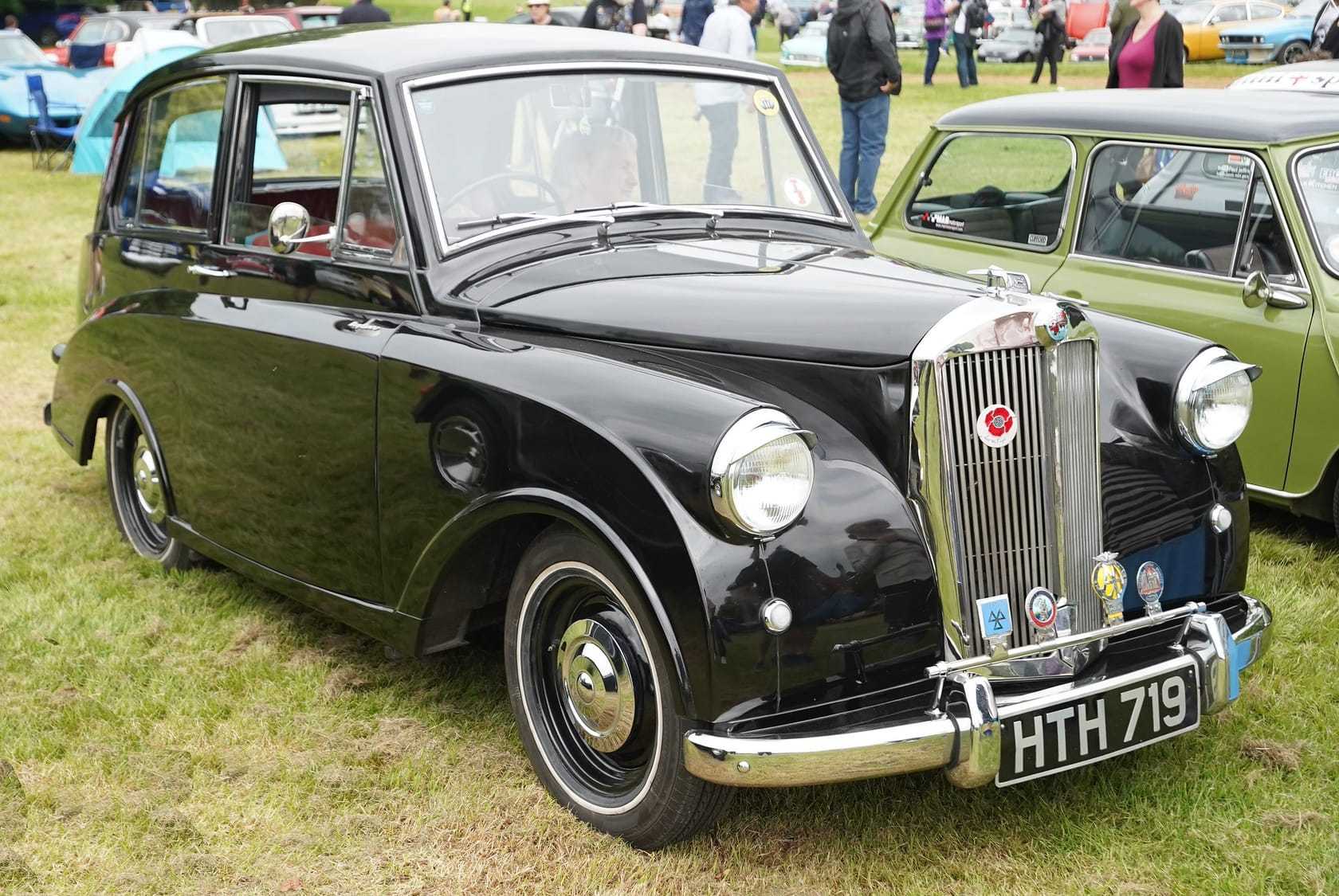 A black 1953 Triumph Mayflower with UK registration HTH 719, front three-quarter view on show ground grass