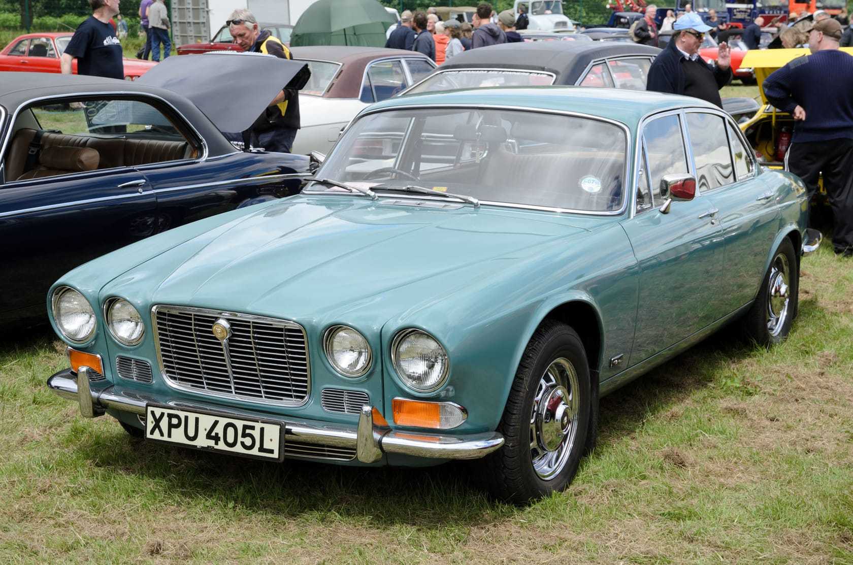A pale blue 1973 Jaguar XJ6 Series 1 2.8 with a UK registration on a show field