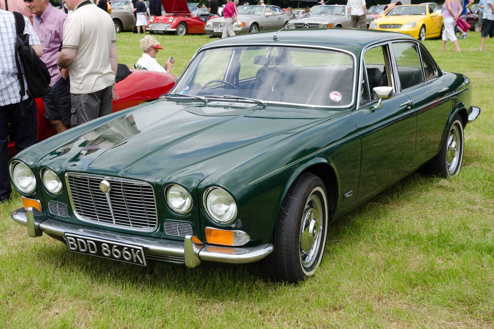 A dark green Jaguar XJ6 Series 1 saloon with chrome bumpers, front three-quarter view