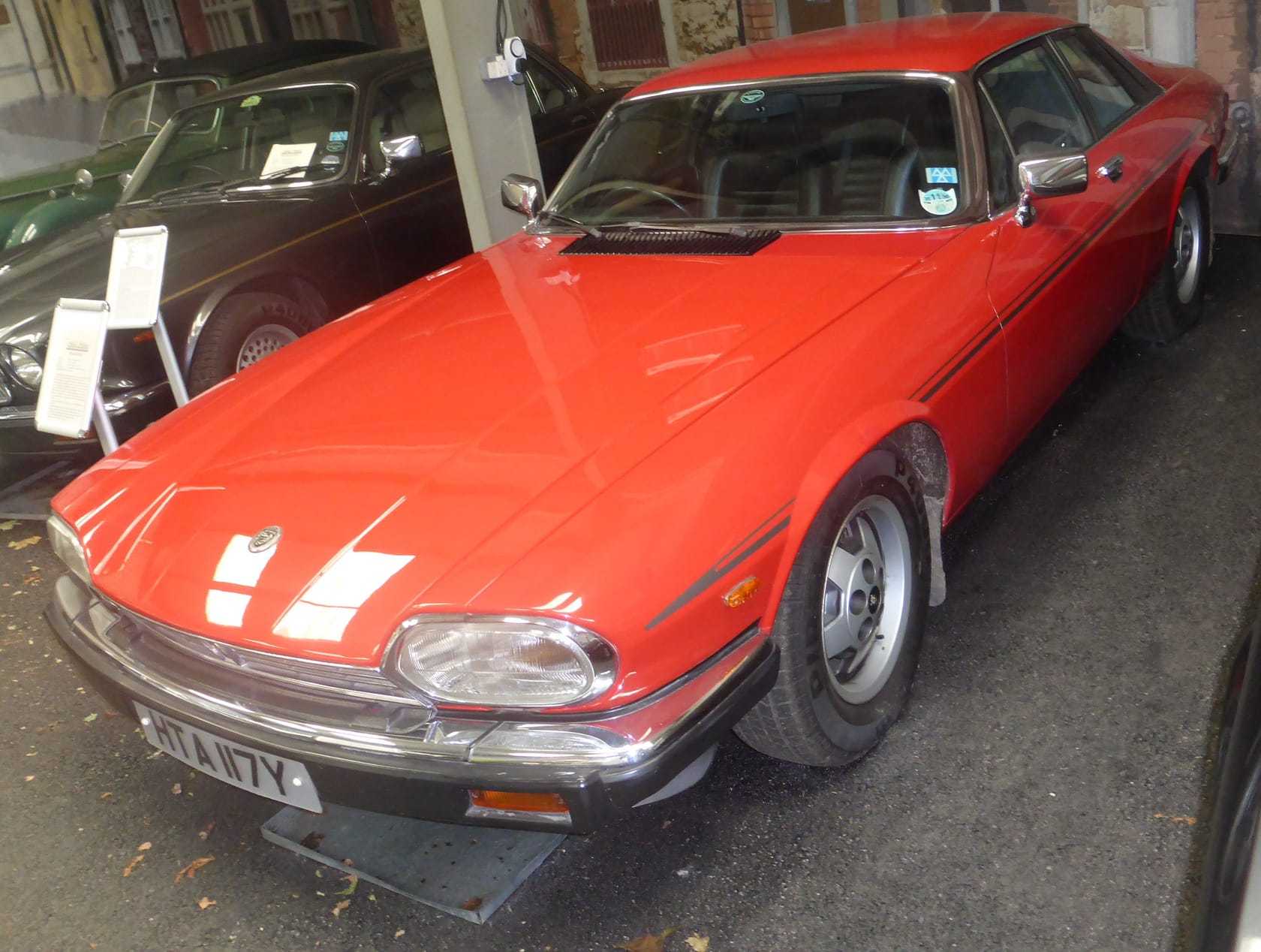 A red Jaguar XJS V12 HE coupe, front three-quarter view