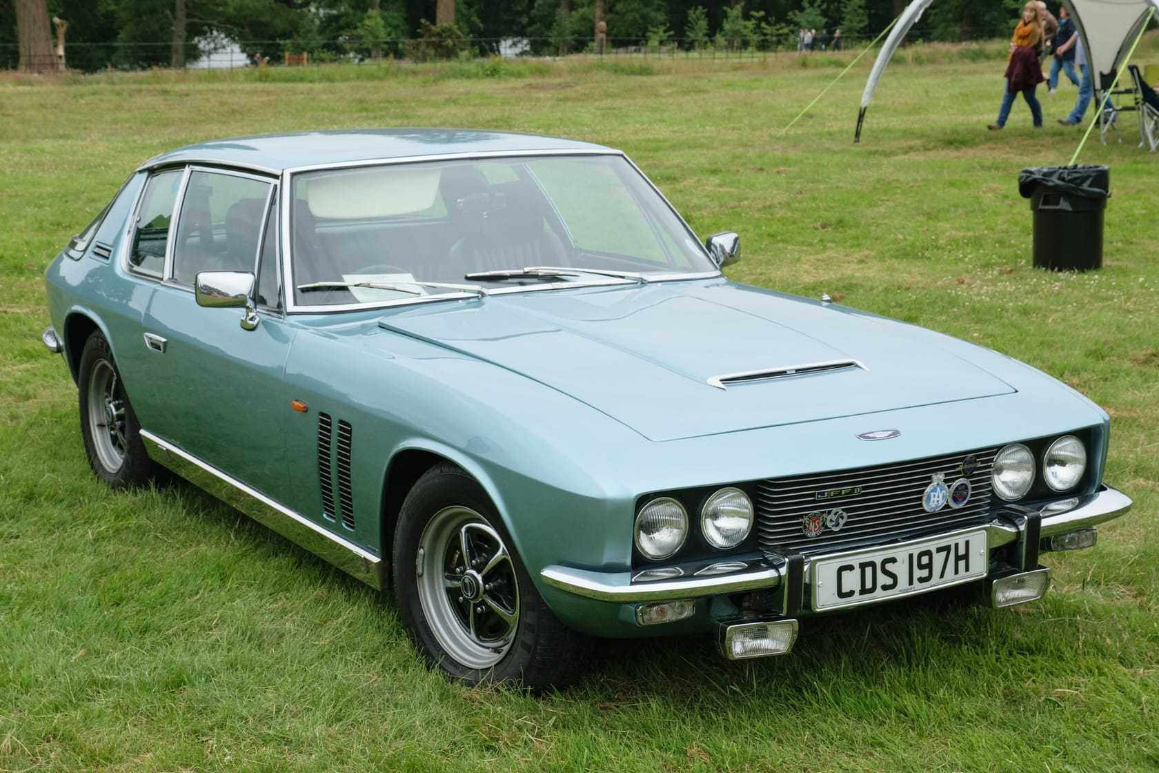 A sage green Jensen FF Mk II on grass at a show, front three-quarter view, UK registration CDS 197H