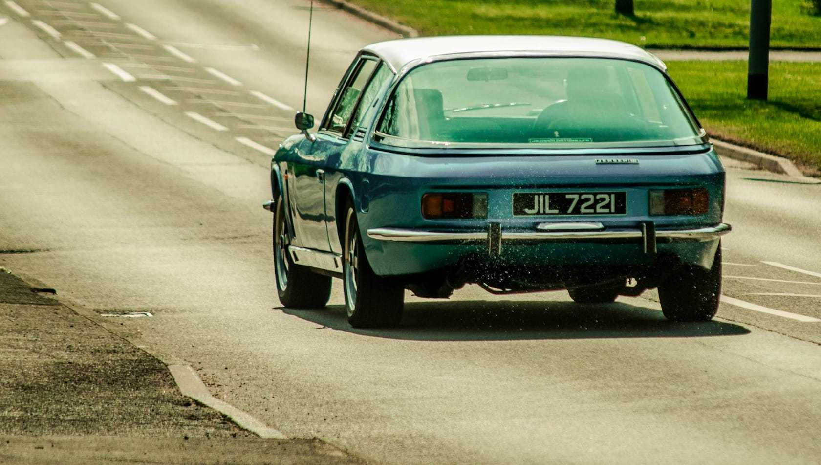 A green Jensen Interceptor seen in profile