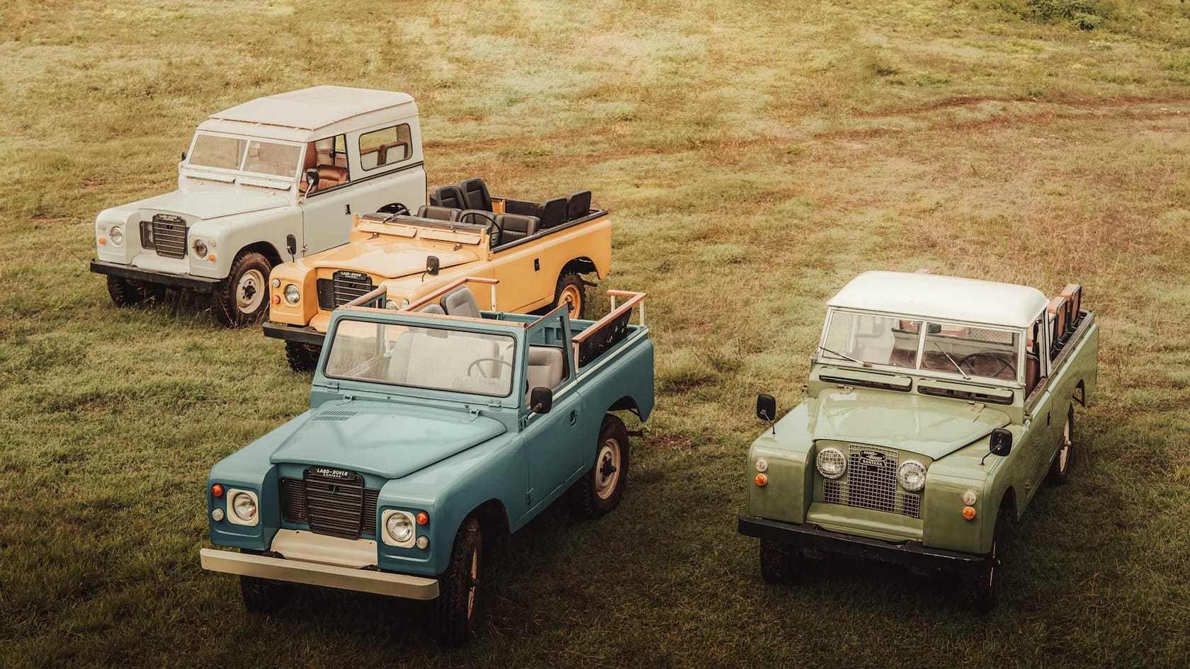 A group of classic Land Rover Series vehicles parked together