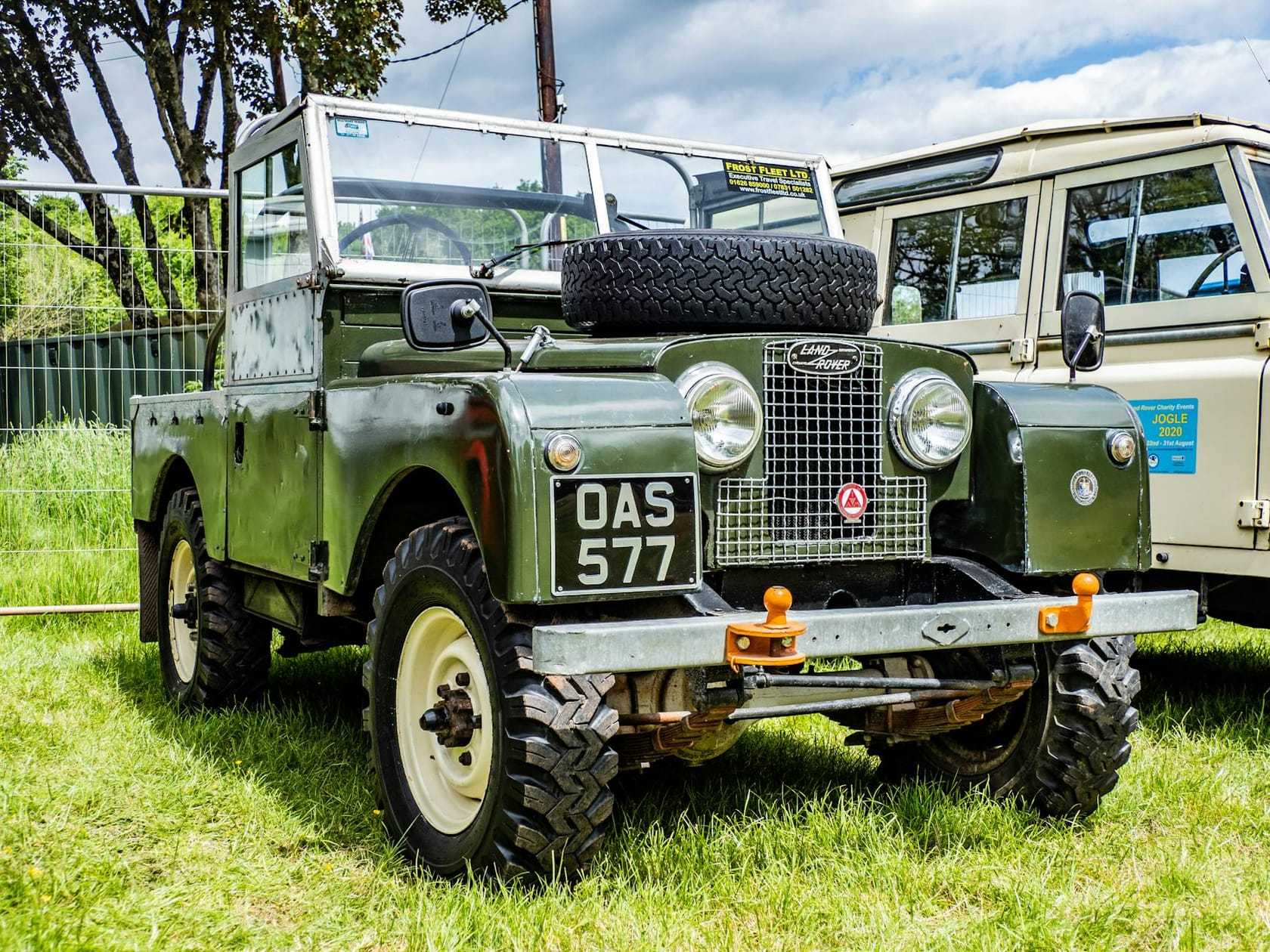 A blue Land Rover Series I at a classic vehicle show