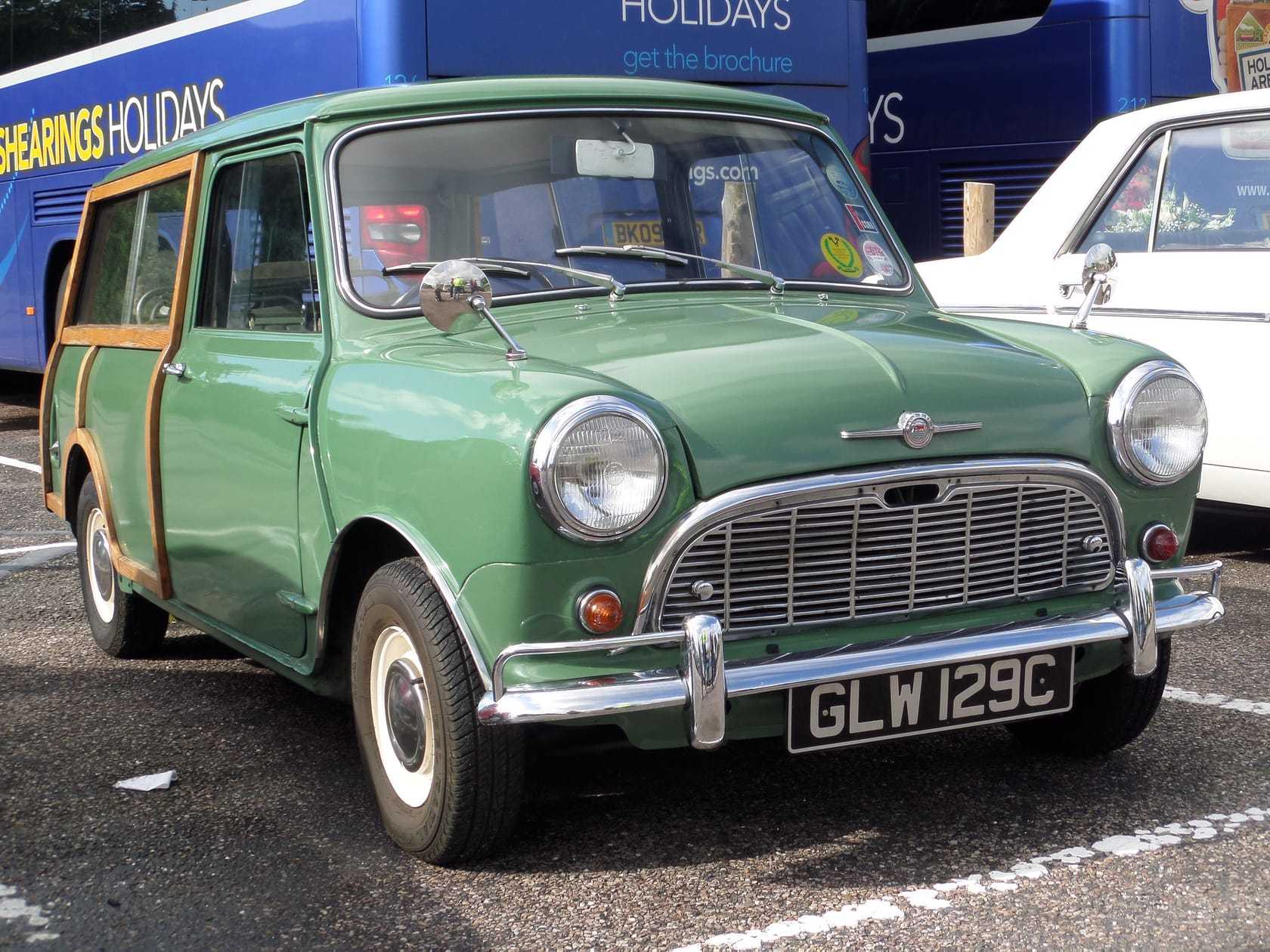A green woody Morris Mini Traveller at a show, front three-quarter view