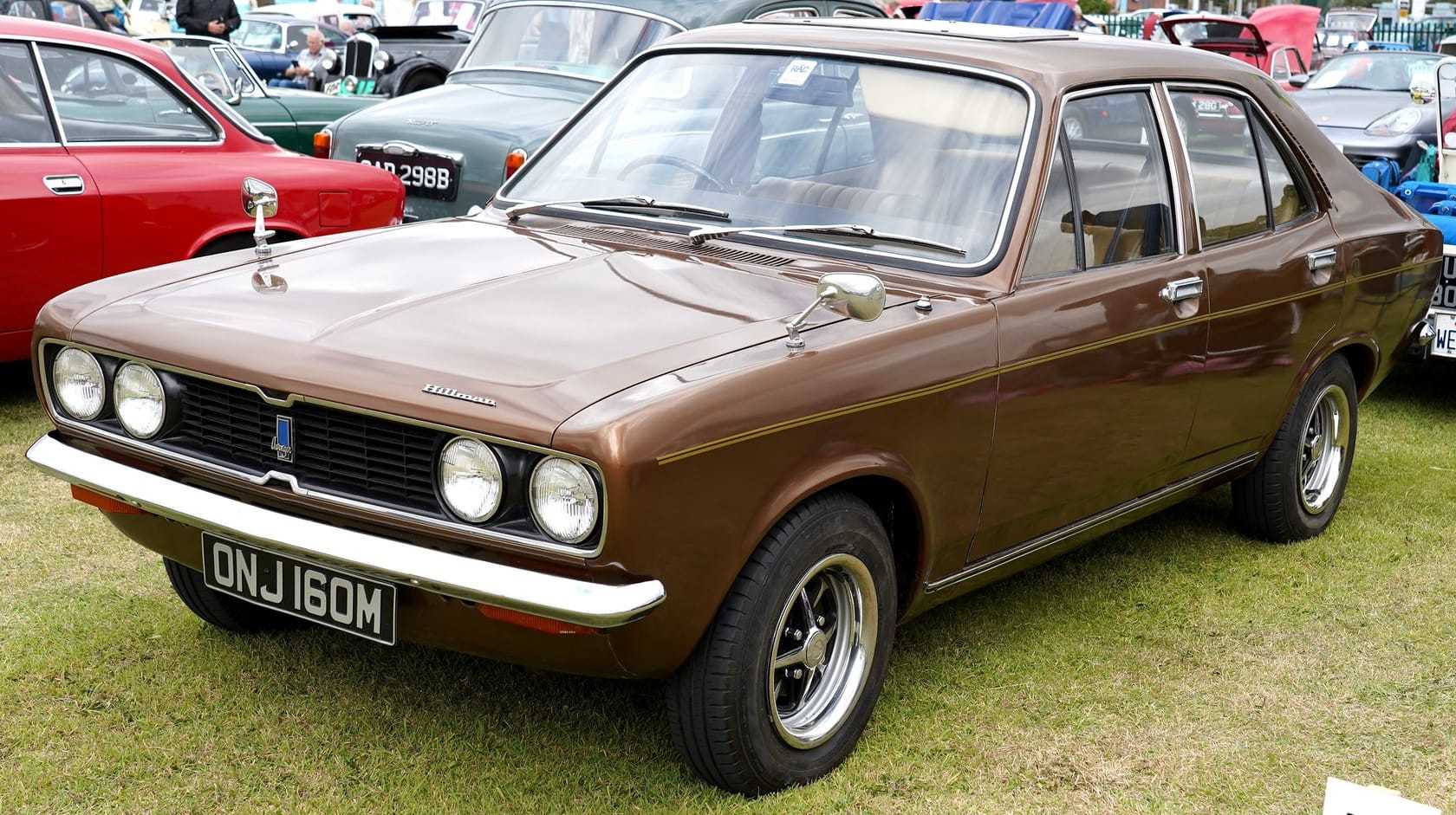 A brown metallic Hillman Avenger four-door saloon (M registration, 1973–74), front three-quarter view at an outdoor classic car show