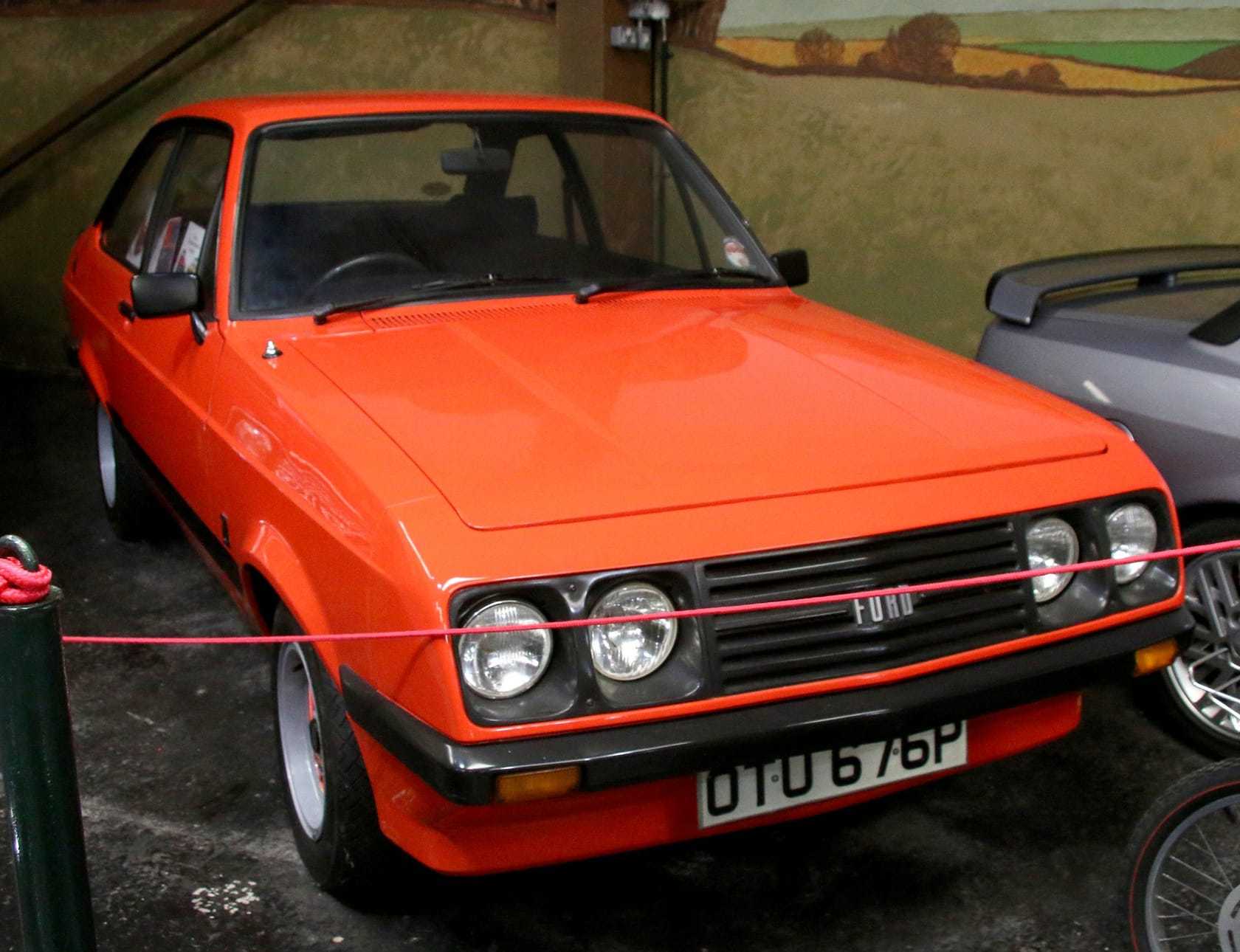 An orange Mk2 Ford Escort RS2000 with the sloping droop-snoot nose, front three-quarter view