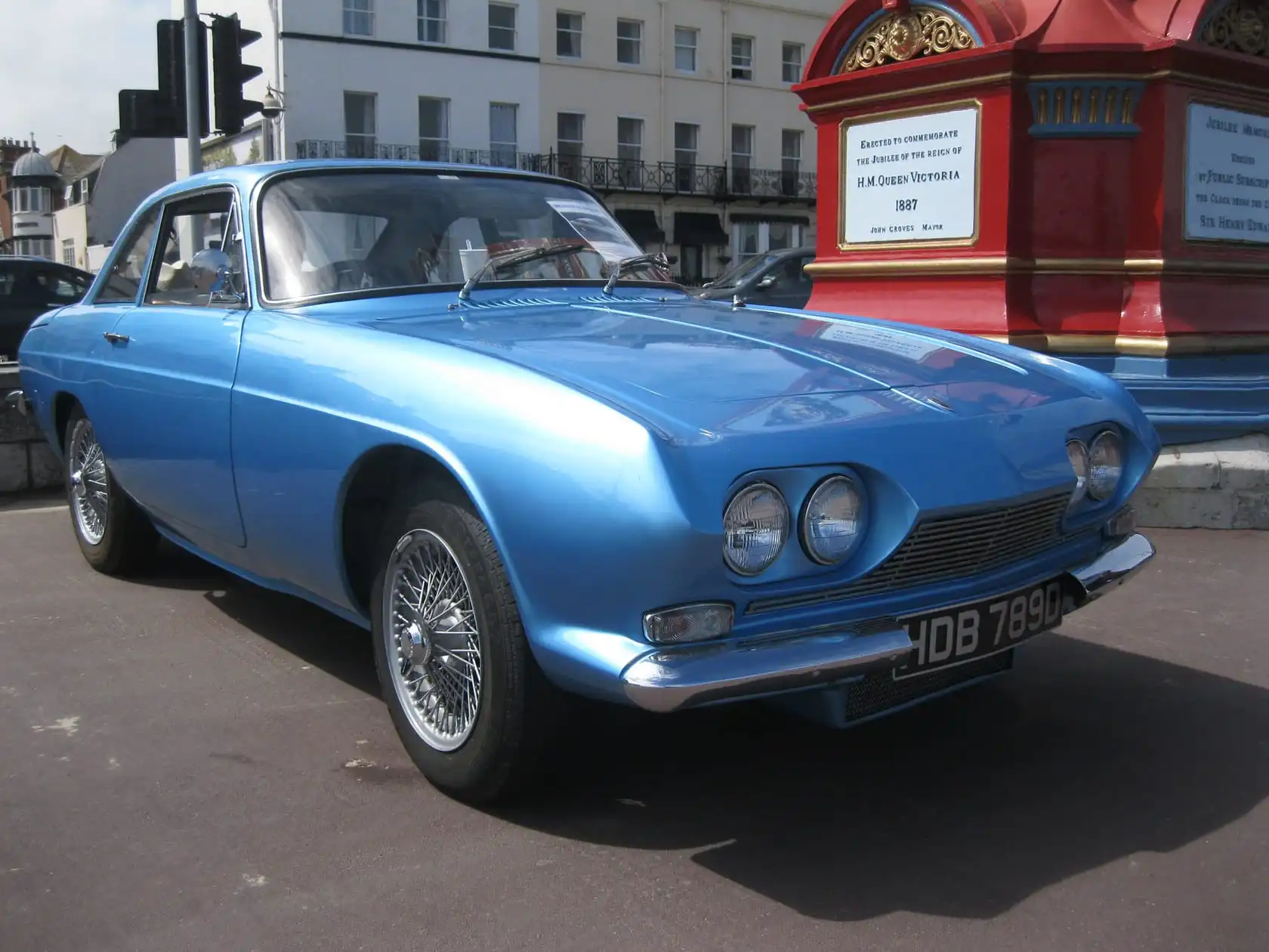 A blue 1966 Reliant Scimitar GT SE4 coupe parked on a street, front three-quarter view, UK registration HDB 789C