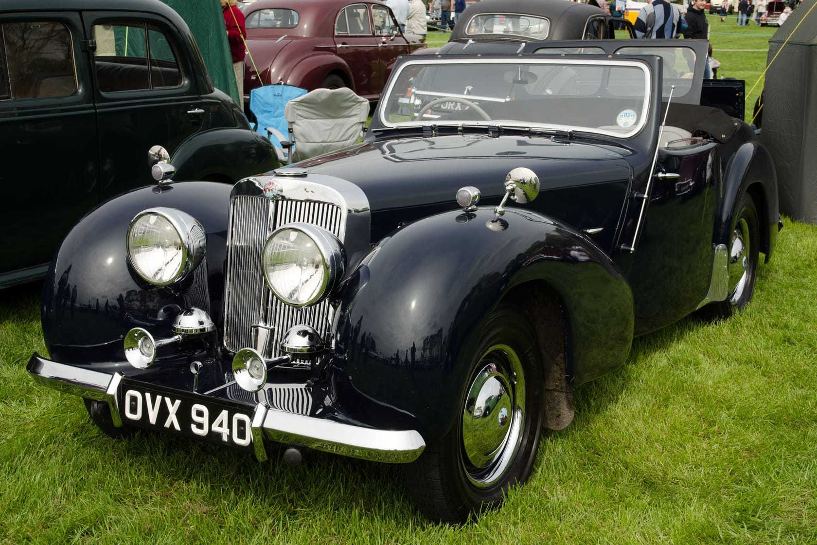 A black 1949 Triumph 2000 Roadster with UK registration OVX 940, front three-quarter view at a classic car show