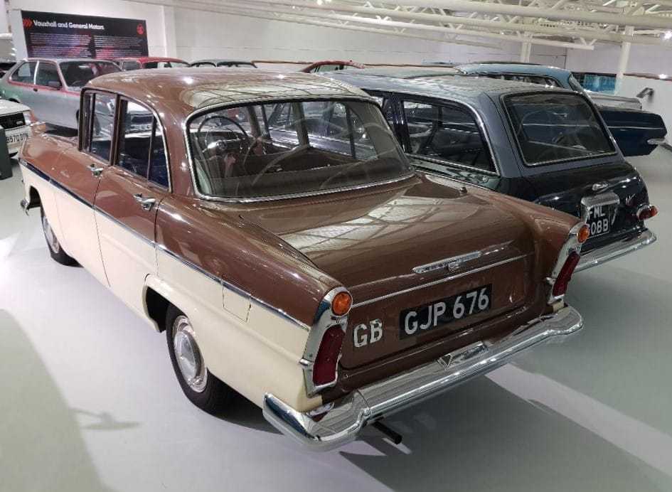 A two-tone brown-and-cream Vauxhall Victor F-Type Series II Deluxe (1960), rear three-quarter view in a museum hall