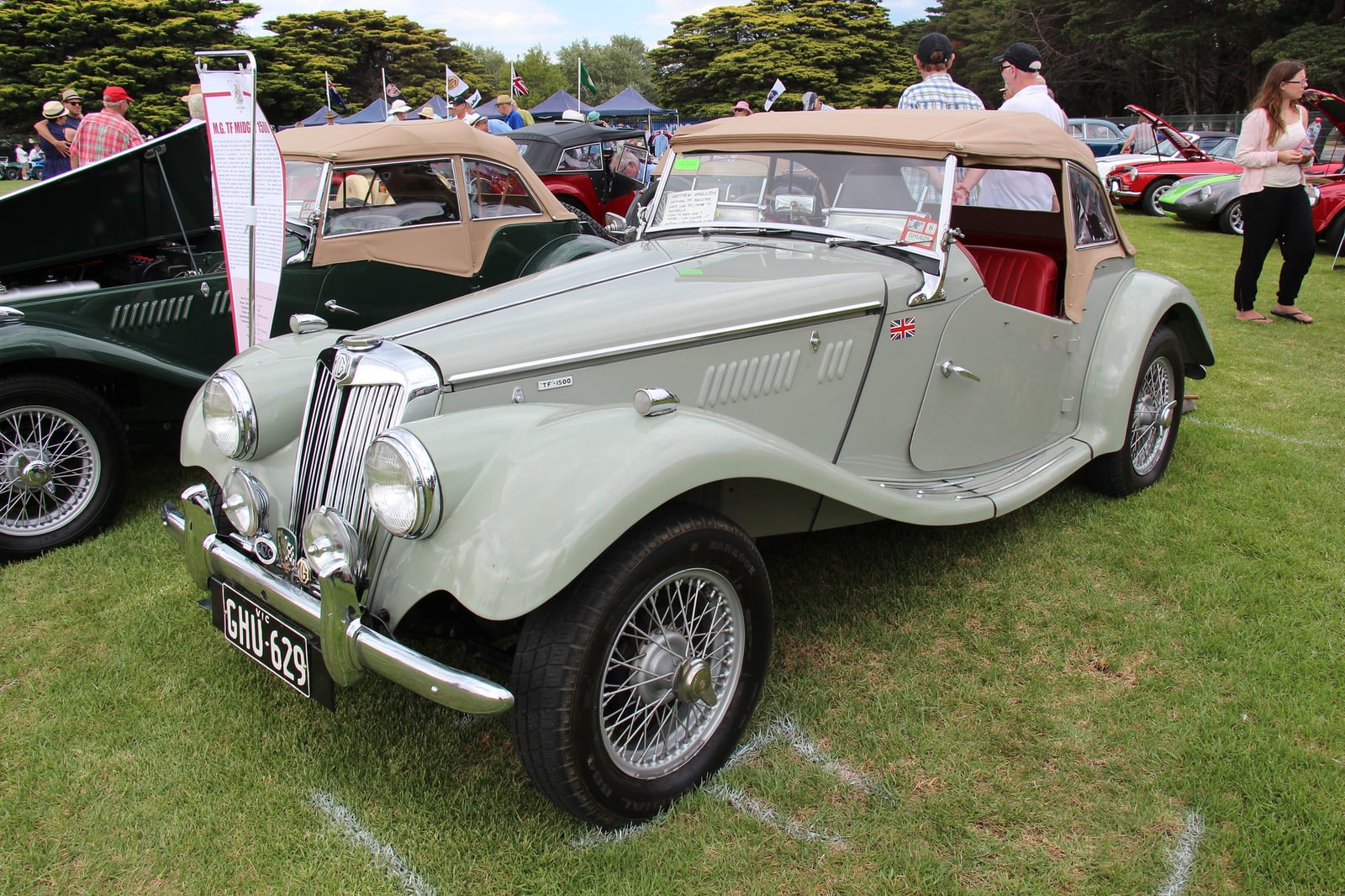 A grey MG TF 1500 of 1954 on grass, front three-quarter view