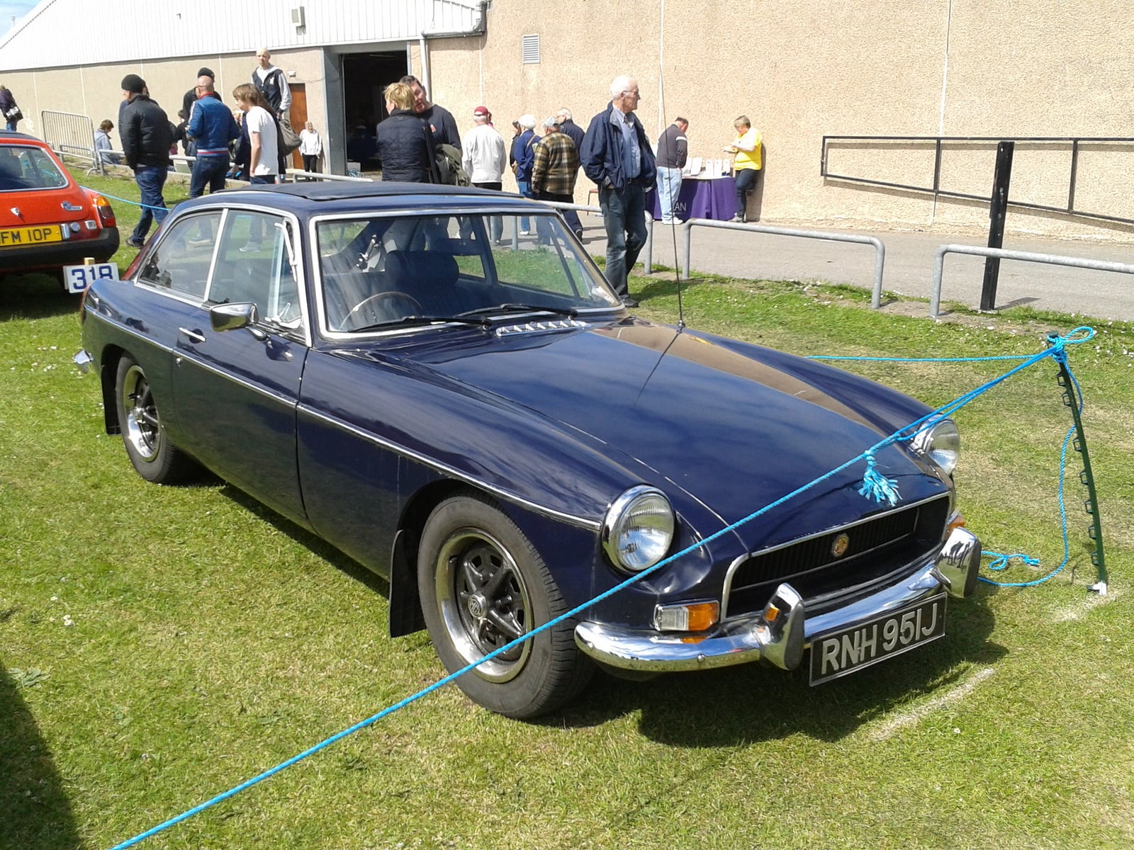 A chrome-bumper MG MGB GT at a show