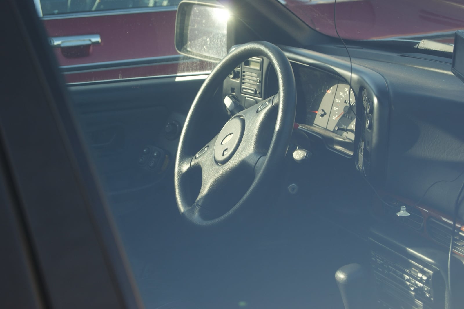 The interior of a Ford Granada Mk3, showing the steering wheel, instrument cluster and dashboard through the driver's window
