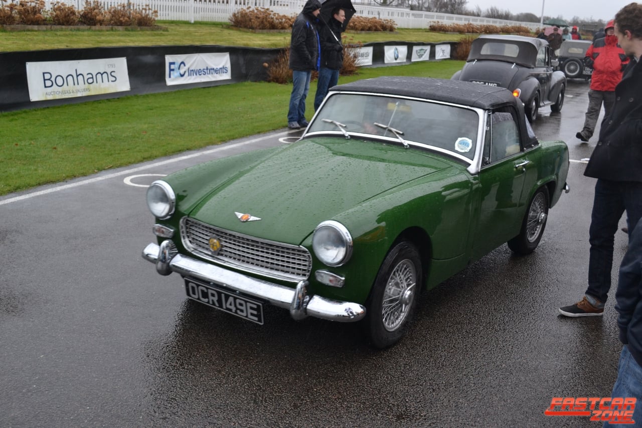 A green later Austin-Healey Sprite (Mk IV) with the hood up, at a classic-car event