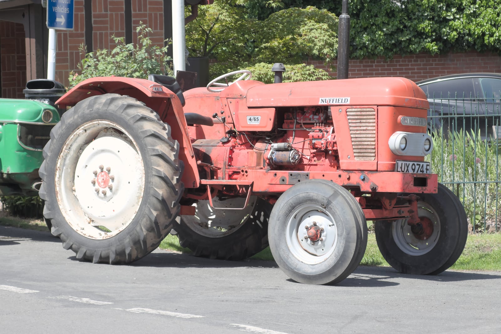 An orange Nuffield 4/65, registration LUX 974F, on a street