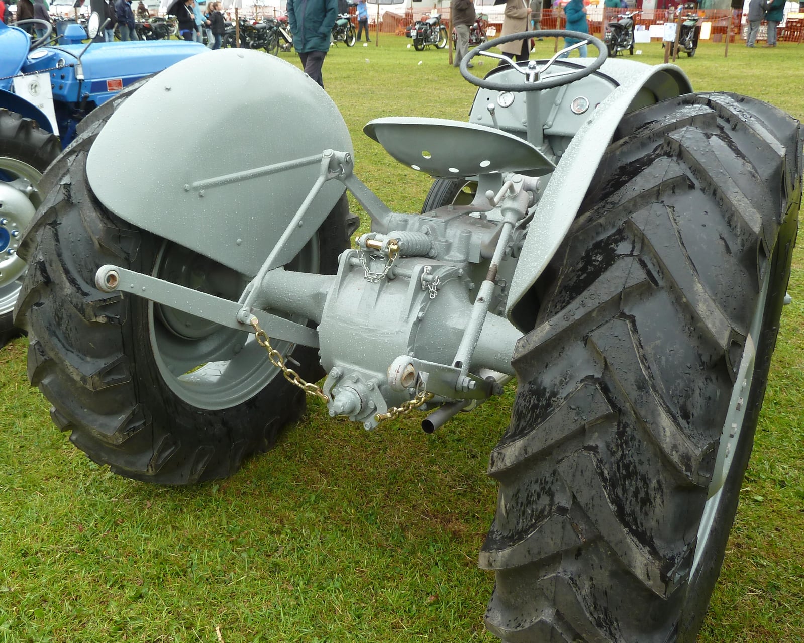 Close-up of the rear three-point hydraulic linkage of a Ferguson TE20, showing the lift arms, top-link mount and power take-off between the rear tyres