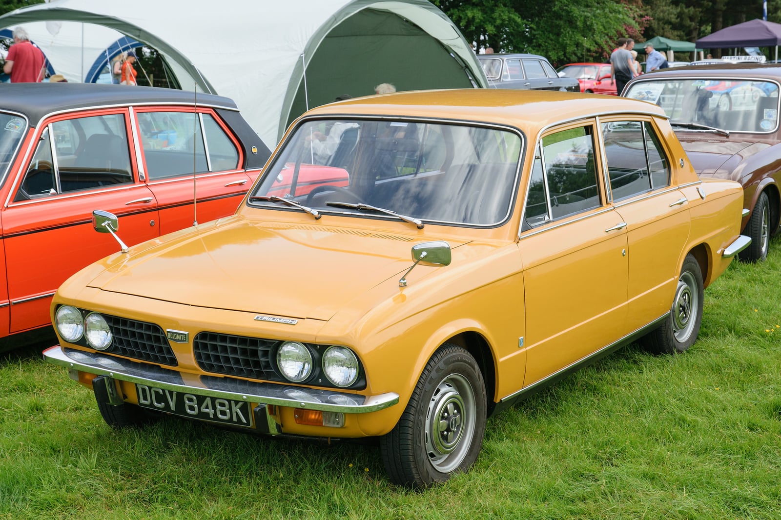 A gold Triumph Dolomite 1850, front three-quarter view at a show