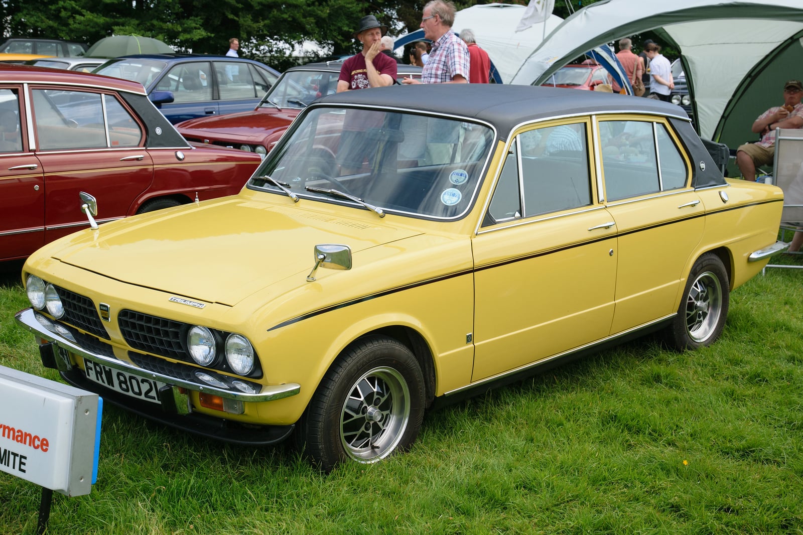 A yellow Triumph Dolomite Sprint, front three-quarter view at a show
