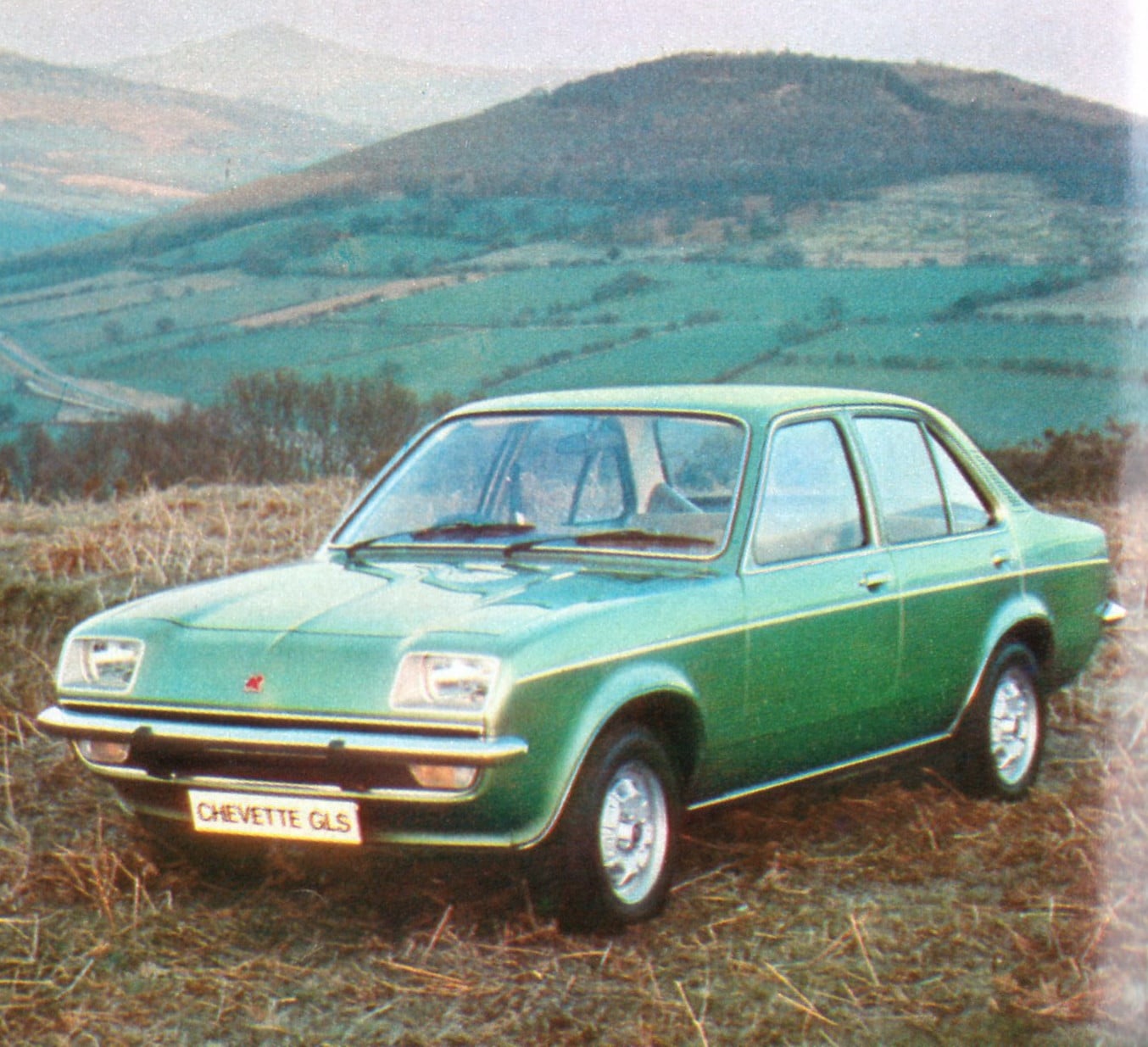 A green Vauxhall Chevette GLS Saloon (1976) photographed against rolling Welsh hills, period brochure shot