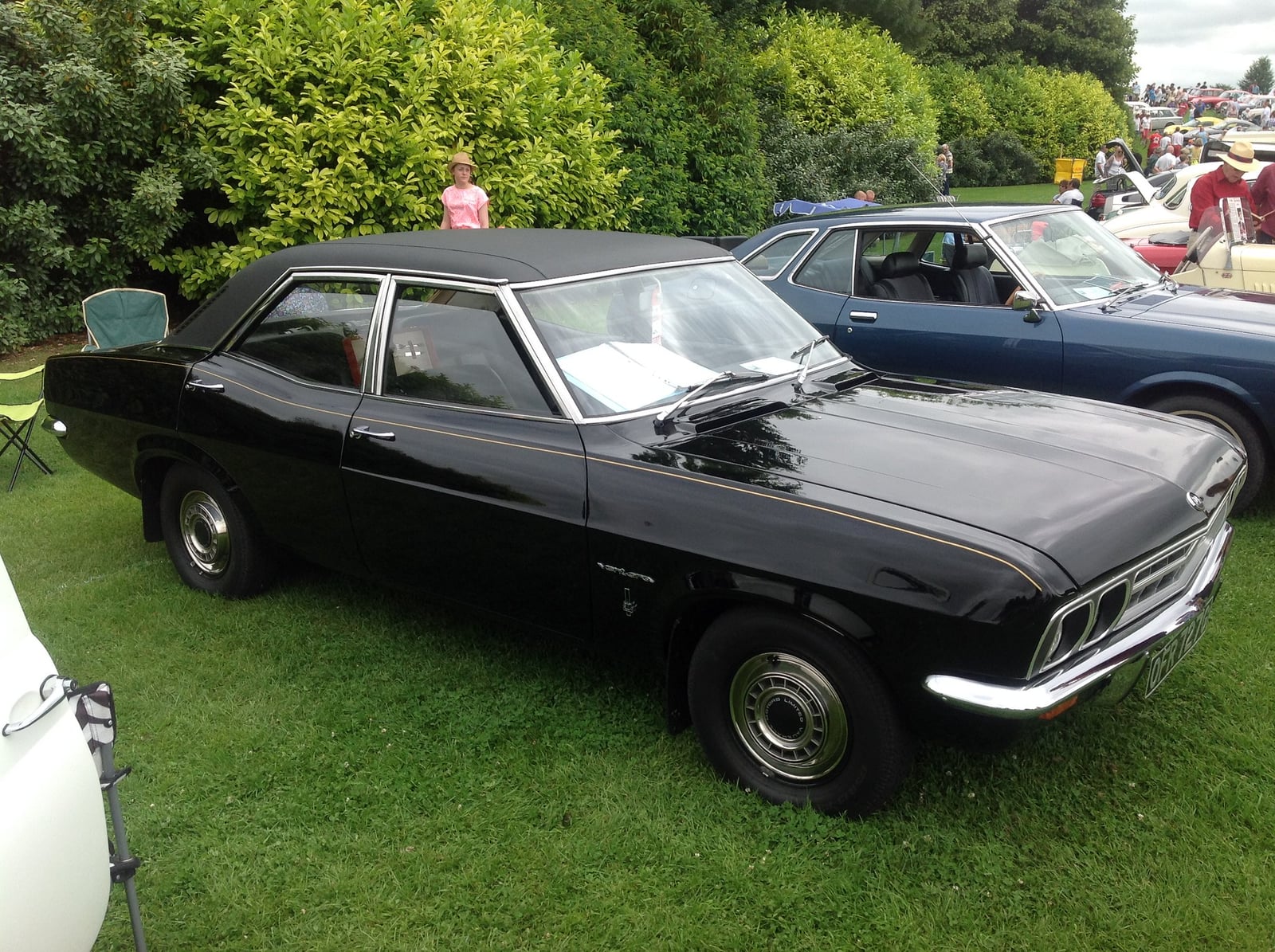 A black Vauxhall Ventora (1969) with a black vinyl roof, front three-quarter view at an outdoor classic car show