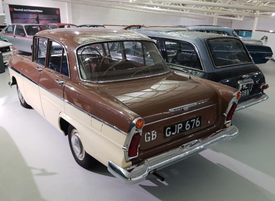 A two-tone brown-and-cream Vauxhall Victor F-Type Series II Deluxe (1960), rear three-quarter view in a museum hall