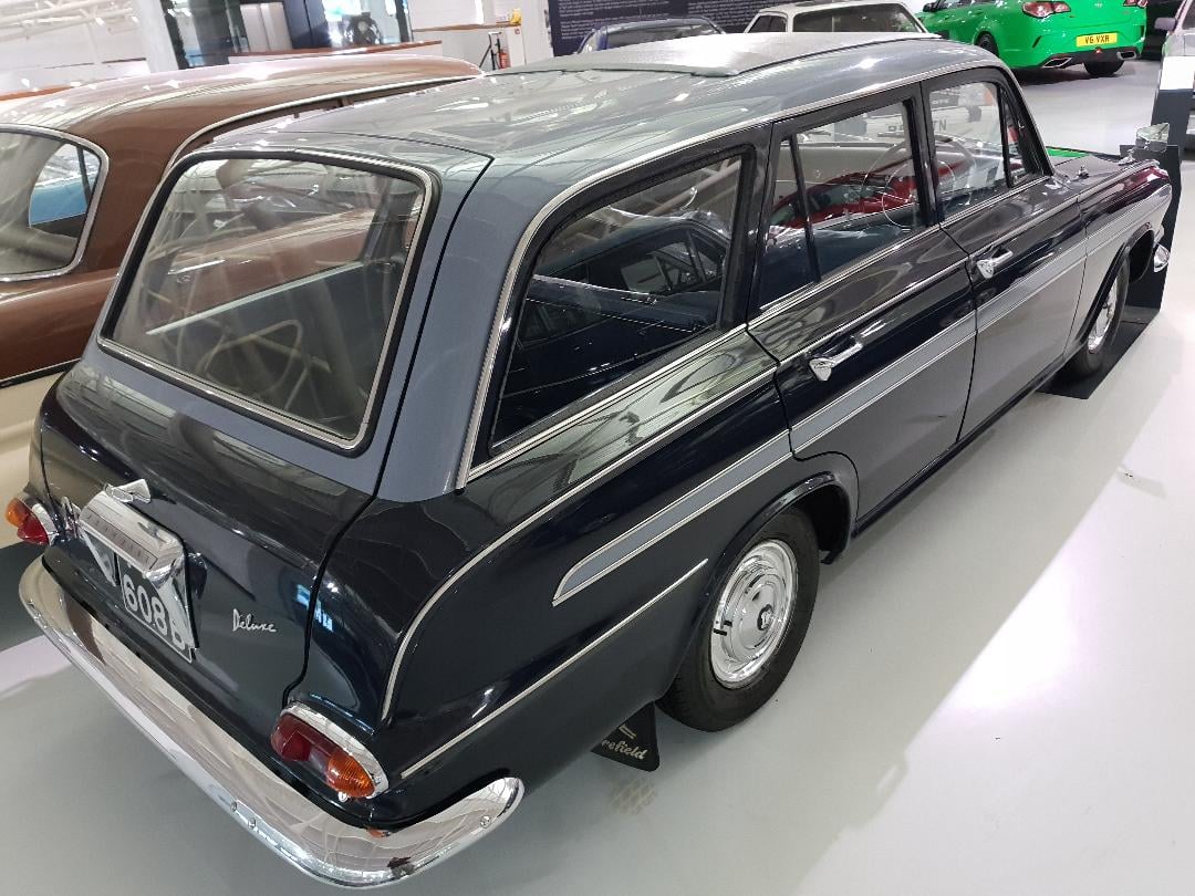 A dark slate-grey Vauxhall Victor FB Deluxe Estate (1964), rear three-quarter view in a museum hall