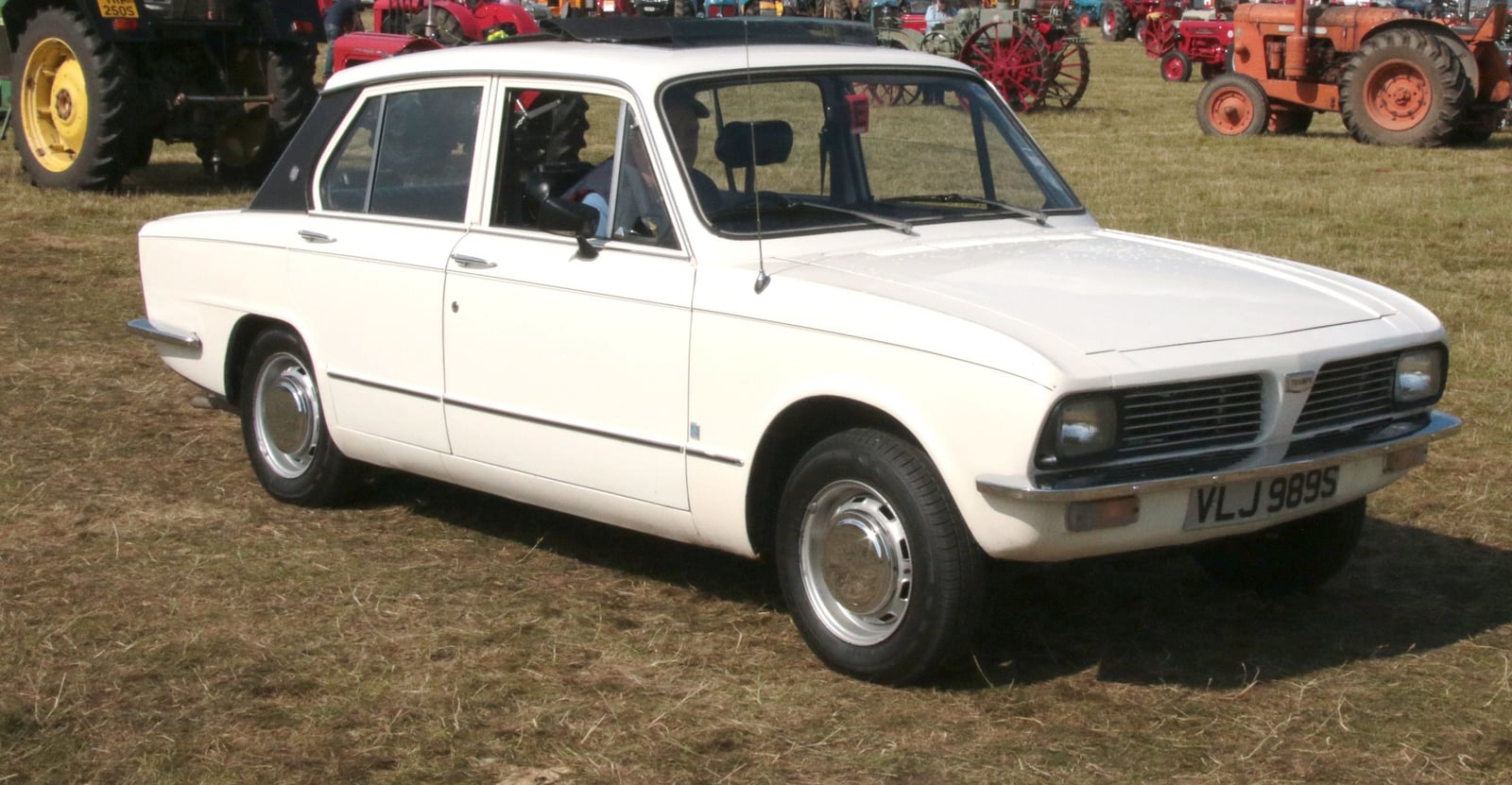 A white Triumph Dolomite saloon, front three-quarter view